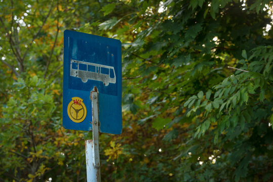 BUS STOP IN THE VILLAGE - An old roadside sign on a local country road