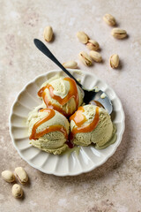 pistachio ice cream scoops on beige plate