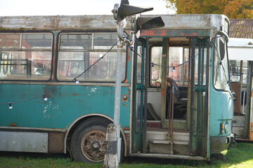 Abandoned Vintage Teal Bus with Open Door and Railroad Crossing Signal