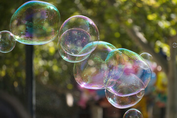 Soap bubbles floating outdoors reflecting abstract colors