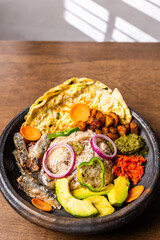 Anwamo (Oiled Rice), Africa Ghana Traditional Dish with Fried Eggs, Sardine, Avocado, and Fried Plantain
