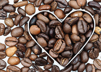 Coffee beans arranged in a heart shape showcasing love for coffee and its rich textures in a creative display