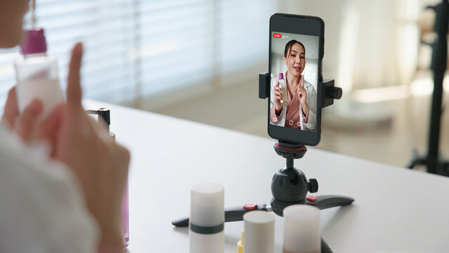 Asia woman people anti aging expert modern health vlogger live advice talk selfie video mobile phone camera. Online digital seller asian small SME store shop owner side hustle filming sell skin care.