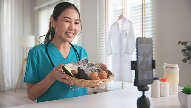 Asia woman people anti aging expert modern health care vlogger live advice talk selfie video mobile phone camera. Online diet food weight loss HDL meal plan recipe digital virtual asian coach filming.