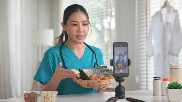 Asia woman people anti aging expert modern health care vlogger live advice talk selfie video mobile phone camera. Online diet food weight loss HDL meal plan recipe digital virtual asian coach filming.