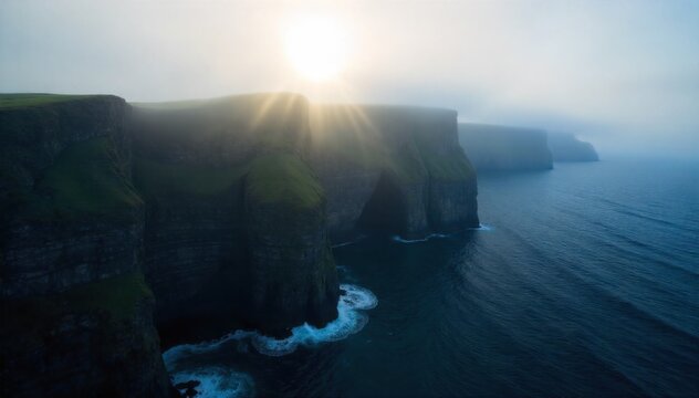 Coastal cliffs emerging from thick sea fog, with the sun just visible. Dramatic, rugged coastal cliffs are partially obscured by a very thick sea fog. The sun is a faint, diffuse glow attempting to