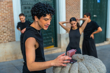 Young dancers preparing for street performance with music