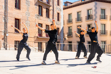 Young dancers performing street dance choreography outdoors