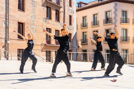 Young dancers performing street dance choreography outdoors