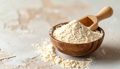 Light beige powder in small bowl with wooden scoop. Protein, food, or natural clay, pigment powder