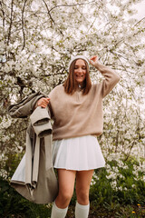 A girl in a light sweater and a white skirt 7270.