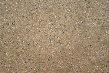 Coarse sand surface pattern in outdoor environmental. Background and textured photo.