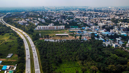 Arial shot of Beautiful road infrastructure of karnataka in India. Aerial view city traffic Highway road with car vehicle movement