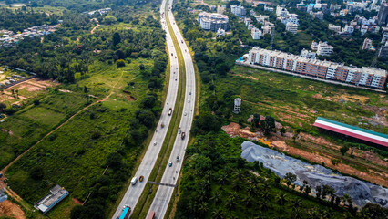 Arial shot of Beautiful road infrastructure of karnataka in India. Aerial view city traffic Highway road with car vehicle movement