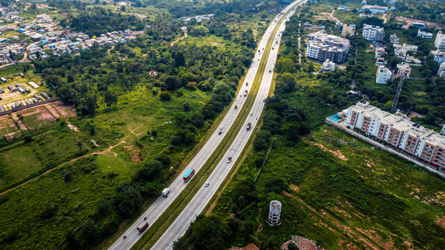 Arial shot of Beautiful road infrastructure of karnataka in India. Aerial view city traffic Highway road with car vehicle movement