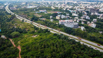 Arial shot of Beautiful road infrastructure of karnataka in India. Aerial view city traffic Highway road with car vehicle movement in Bangalore. © Sumit