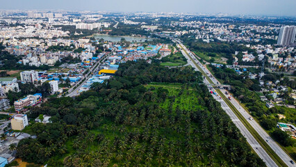 Arial shot of Beautiful road infrastructure of karnataka in India. Aerial view city traffic Highway road with car vehicle movement in Bangalore.