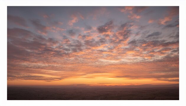 Soft altocumulus clouds glowing in the warm morning sky at sunrise
