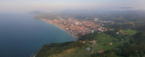 Panoramic drone view of Zarautz town on summer sunset. Basque Country, Spain.