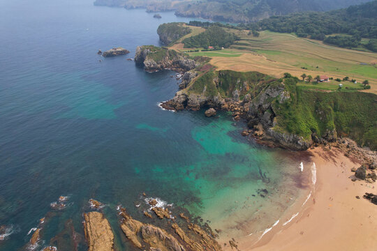 Aerial view of Amio Beach and coastline of Cantabria on sunny summer day. Pechon, Spain.
