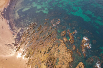 Top aerial view of Amio Beach on sunny summer day. Pechon, Cantabria, Spain.