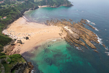 Drone view of Amio Beach on sunny day. Pechon, Cantabria, Spain.