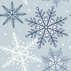 Seamless pattern of stylized snowflakes and dots in blue and white on a light blue background perfect for winter holidays and seasonal designs