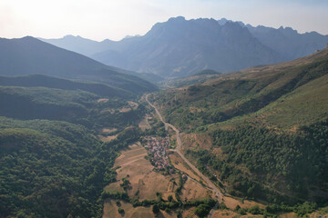 Aerial view of Santa Marina de Valdeon village on sunny summer evening. Picos de Europa, Leon, Spain.