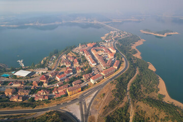 Aerial view of Riaño town and reservoir on misty summer morning. Castile and Leon, Spain.