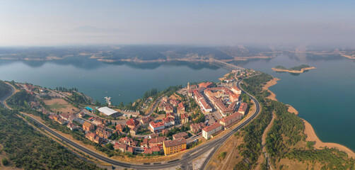 Panoramic aerial view of Riaño town and reservoir on misty summer morning. Castile and Leon, Spain.