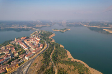 View of Riaño town and reservoir on misty summer morning. Castile and Leon, Spain.
