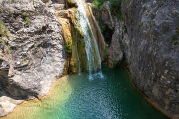 Drone view of La Gorguina waterfall in Gorg Gorge (Barranc del Gorg) on sunny summer day. La Febr&oacute;, Tarragona, Spain.