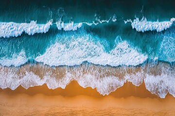 Aerial view of waves crashing onto sandy beach, turquoise ocean