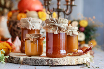 Glass jars with pumpkin preserves on the table.