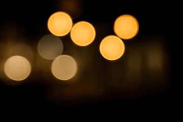 Soft, glowing orbs float in the darkness, out of focus