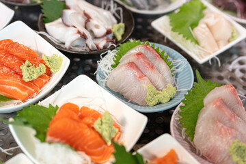 Freshness raw white seabass meat, Japanese sashimi food menu that prepared in dish for sale at fish market. Food and object, close-up with selective focus.