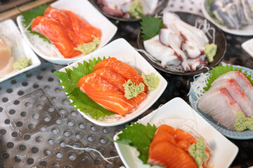Freshness raw salmon meat, Japanese sashimi food menu that prepared in dish for sale at fish market. Food and object, close-up with selective focus.