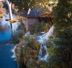 A long exposure photo of a picturesque waterfall in Rastoke, Croatia, famous for its many water cascades and mills.
