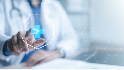 A doctor touching a digital health shield icon with a blue cross, representing healthcare insurance...