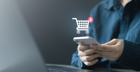 wishlist, save, shopping, ecommerce, A person holding a smartphone with a shopping cart icon, representing wishlist saving, e-commerce shopping, favorite products, and mobile retail experience.