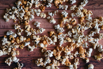 spilled popcorn on a wooden table