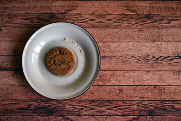 oatmeal cookies on a white saucer on a wooden table