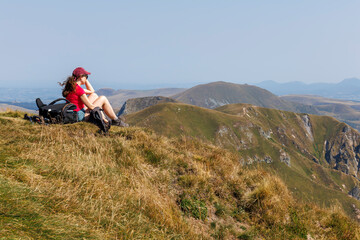 A tourist admiring the landscape of Massif du Sancy in Auvergne, France