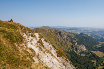 A tourist admiring the landscape of Auvergne during the summer