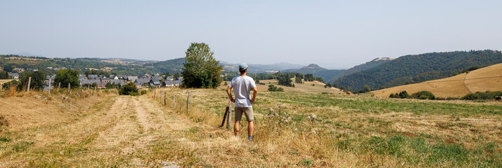 Panoramic view of a tourist admiring the scenery in Besse-et-Saint-Anastaise, France