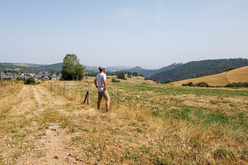 A tourist admiring the landscape of Besse-et-Saint-Anastaise, France