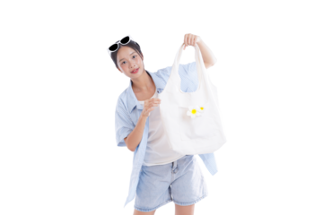 Stylish Woman Showcases Bag: A trendy woman cheerfully poses, her sun-kissed face beaming as she showcases a charming tote bag, perfect for a casual day out.