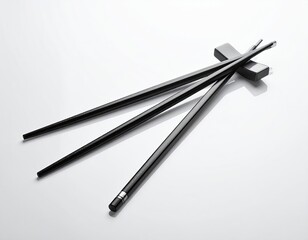 Elegant Black Chopsticks Resting on a White Surface in a Studio with Soft Lighting
