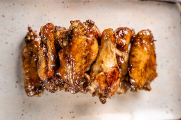Top view of golden glazed chicken wings