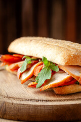 Ciabatta sandwich with smoked meat and arugula